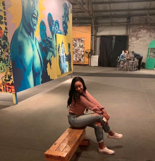 girl sitting down on bench in museum in new orleans
