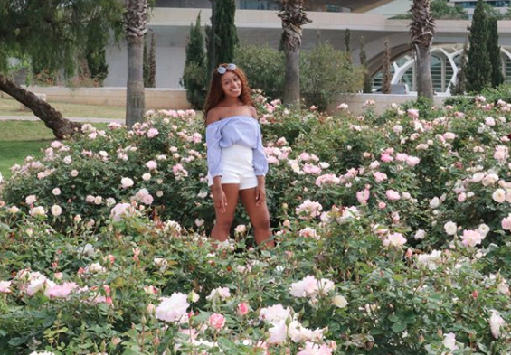 Georgina standing in flower garden